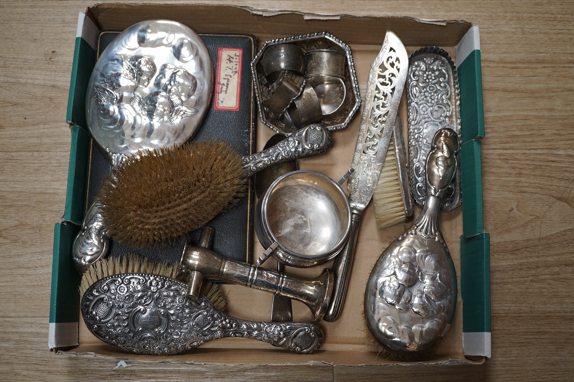 A mixed group of silver including mounted hand mirror, brushes, sugar bowl, napkin rings, bonbon dish, fish slice, part cased set of teaspoons, etc. Condition - poor to fair